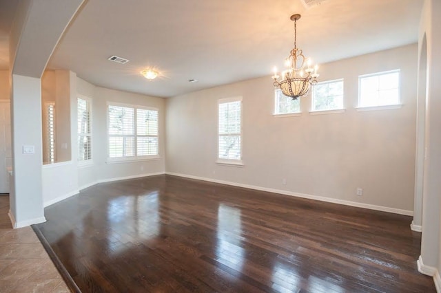 7901 SW Pkwy Unit 16, Austin, TX 78735 - unfurnished room featuring arched walkways, hardwood / wood-style flooring, and a chandelier