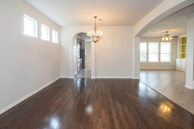 7901 SW Pkwy Unit 16, Austin, TX 78735 - unfurnished dining area with arched walkways, a ceiling fan, healthy amount of natural light, and dark wood-style flooring