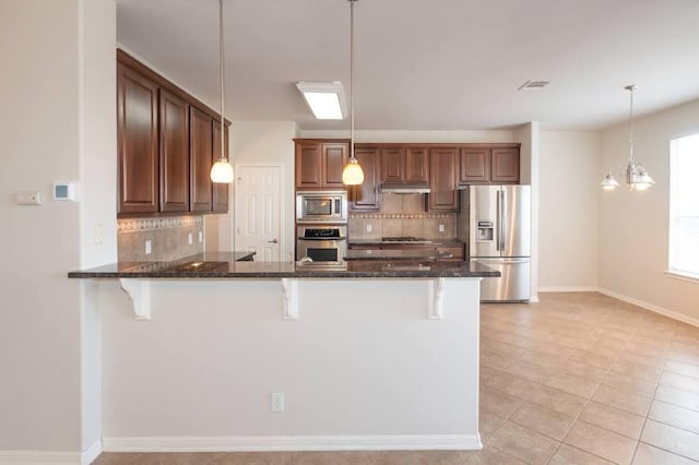 7901 SW Pkwy Unit 16, Austin, TX 78735 - kitchen with appliances with stainless steel finishes, tasteful backsplash, and a kitchen breakfast bar