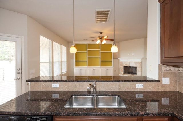 7901 SW Pkwy Unit 16, Austin, TX 78735 - kitchen with ceiling fan, backsplash, dishwashing machine, and dark stone counters