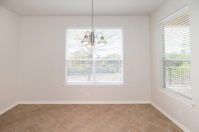 7901 SW Pkwy Unit 16, Austin, TX 78735 - unfurnished dining area featuring a chandelier and baseboards