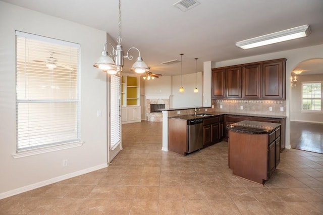 kitchen featuring a sink, dishwasher, a peninsula, open floor plan, and visible vents