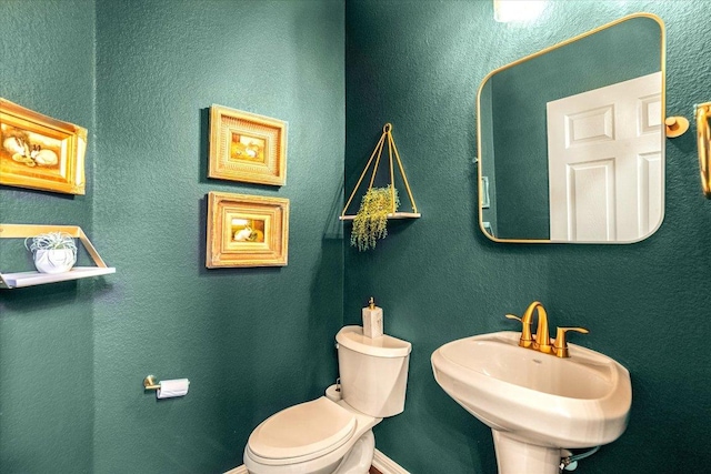 bathroom featuring toilet and a sink