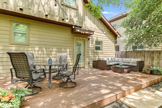 deck featuring fence, outdoor dining area, and outdoor lounge area