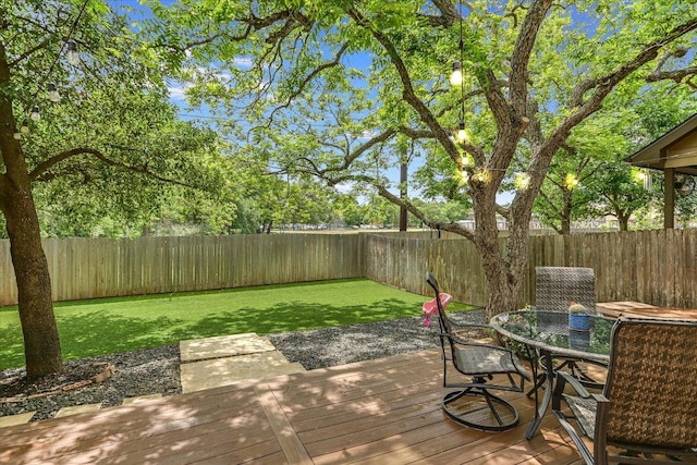 wooden deck with a yard, a fenced backyard, and outdoor dining space