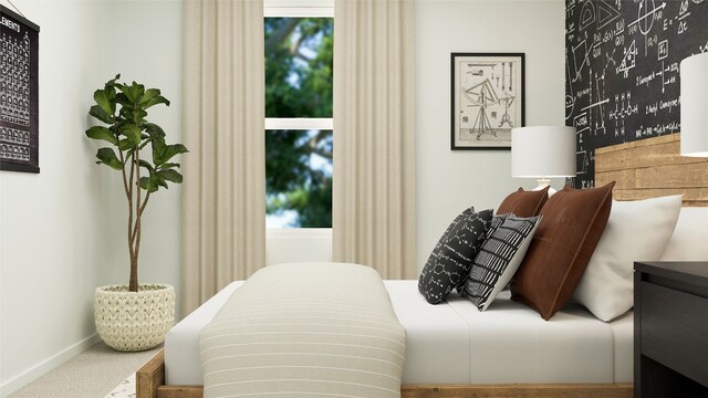 bedroom with baseboards and carpet