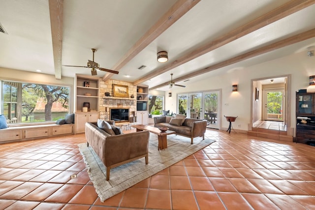tiled living area with baseboards, a ceiling fan, a stone fireplace, and visible vents