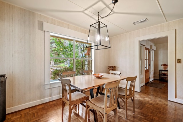 dining room featuring baseboards, visible vents, and wallpapered walls
