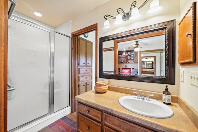 bathroom featuring vanity, ceiling fan, a stall shower, and recessed lighting