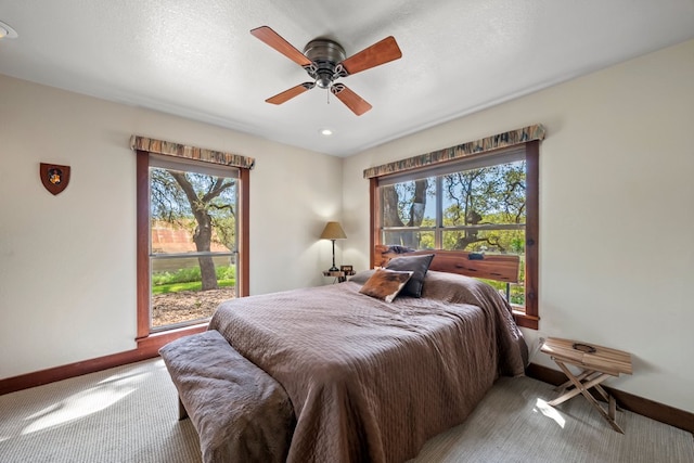 carpeted bedroom with a ceiling fan, baseboards, and recessed lighting