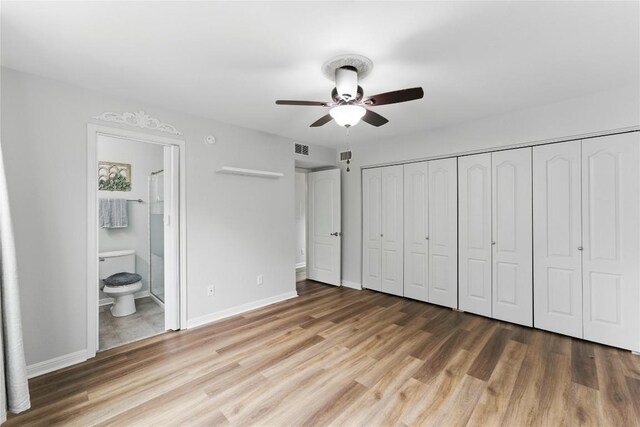 unfurnished bedroom with light wood-style floors, baseboards, ensuite bath, and visible vents