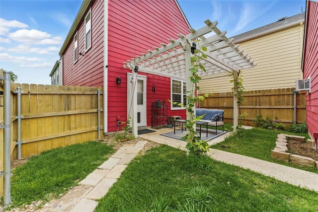 exterior space featuring a lawn, a fenced backyard, a pergola, and a patio