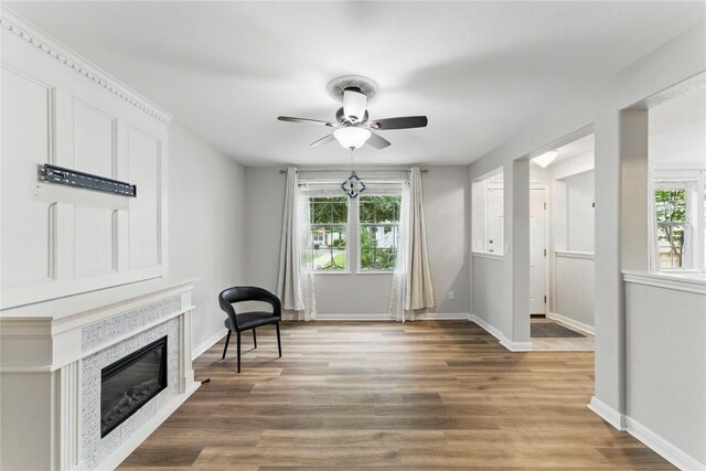 unfurnished room featuring baseboards, ceiling fan, and a wealth of natural light