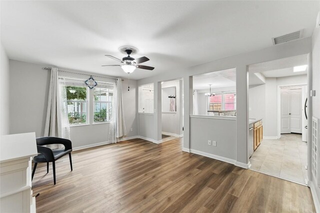 unfurnished room with visible vents, baseboards, plenty of natural light, and light wood-type flooring