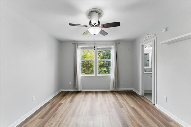 interior space with light wood-style floors, baseboards, and ceiling fan