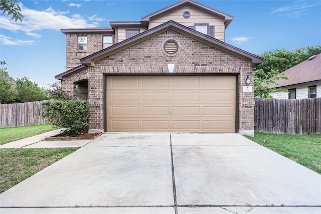 view of front facade with brick siding, driveway, fence, and a garage