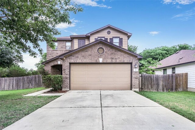 traditional-style house with fence, driveway, a front lawn, and brick siding