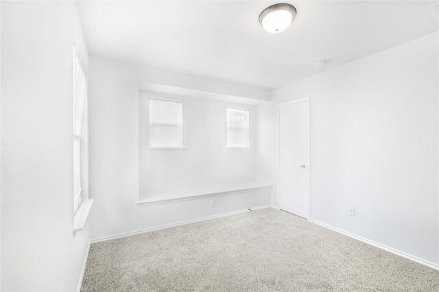 carpeted empty room with baseboards