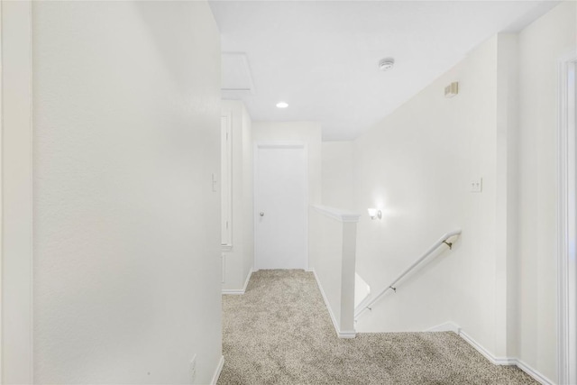 corridor featuring carpet floors, recessed lighting, baseboards, and an upstairs landing
