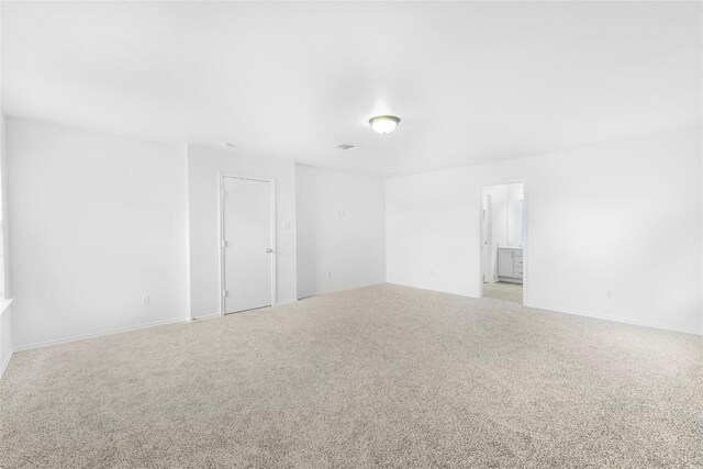unfurnished room with light colored carpet