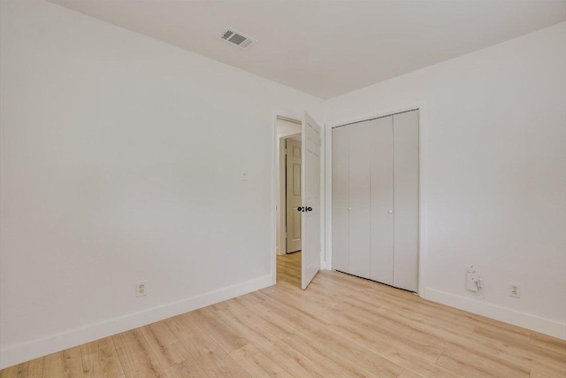 502 Tilbury Ln, Austin, TX 78745 - unfurnished bedroom with wood finished floors and a closet