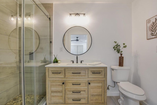 full bath with toilet, ceiling fan, a shower stall, and vanity