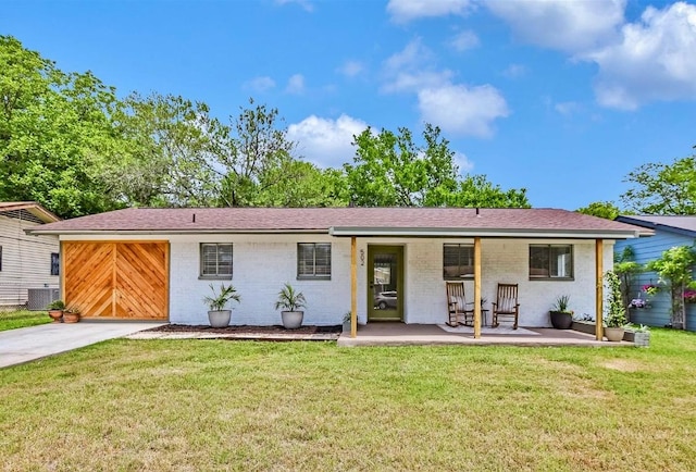 ranch-style house featuring central air condition unit, brick siding, concrete driveway, and a front lawn