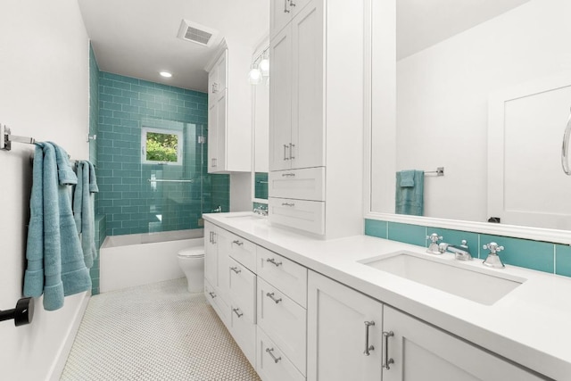full bathroom with visible vents, a sink, double vanity, and toilet