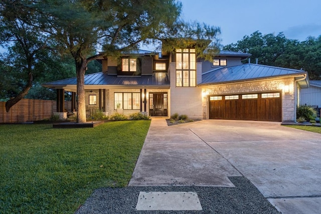 view of front of home with fence, a front yard, a standing seam roof, covered porch, and metal roof