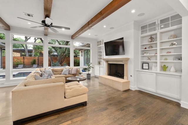 living room featuring visible vents, a ceiling fan, beam ceiling, and a wealth of natural light