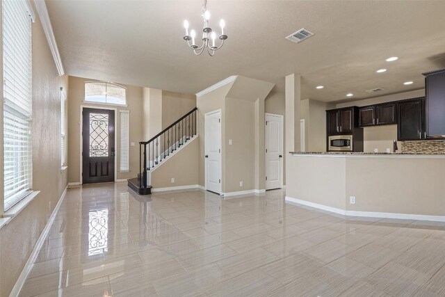 interior space with light tile patterned flooring, a notable chandelier, recessed lighting, baseboards, and visible vents
