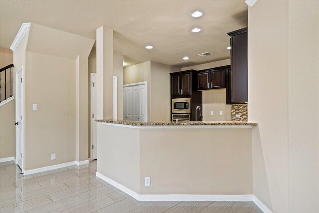 kitchen featuring visible vents, baseboards, light stone countertops, and stainless steel appliances