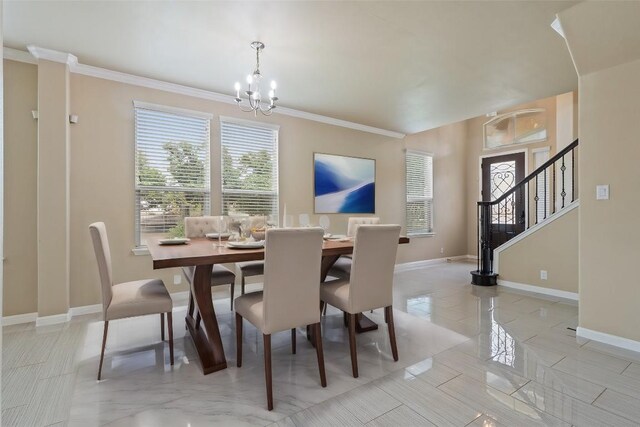 dining room featuring an inviting chandelier, baseboards, ornamental molding, and stairs