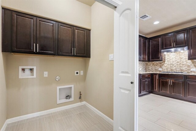 laundry room with cabinet space, hookup for a washing machine, gas dryer hookup, electric dryer hookup, and visible vents