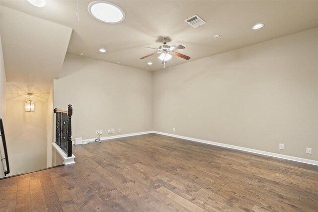 spare room with a ceiling fan, visible vents, wood finished floors, baseboards, and recessed lighting
