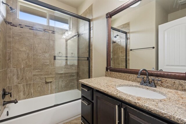 bathroom with enclosed tub / shower combo and vanity