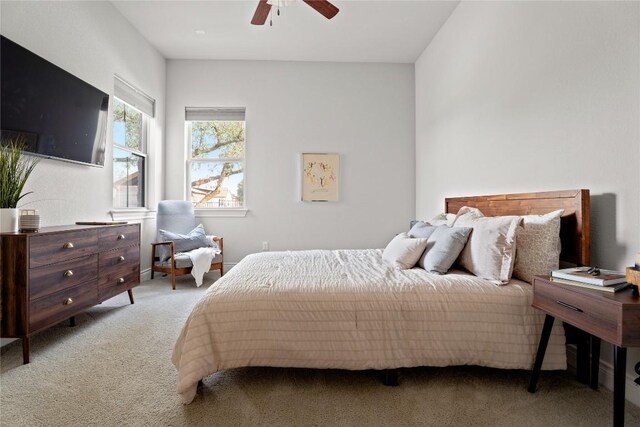bedroom with ceiling fan and light carpet