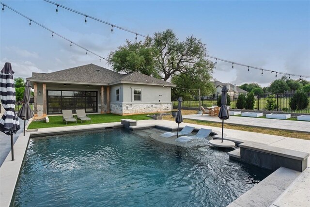view of swimming pool with a patio, fence, and a fenced in pool