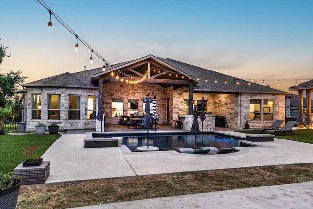 back of property at dusk featuring a lawn, a patio, a fenced in pool, and roof with shingles