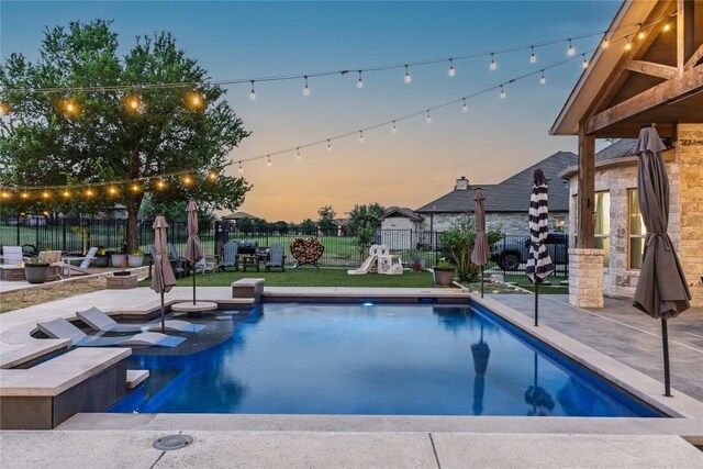 view of pool featuring a fenced in pool, an outdoor fire pit, fence, and a patio
