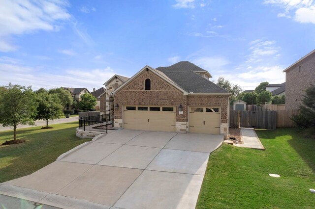 view of front of property with fence, a front yard, brick siding, concrete driveway, and an attached garage