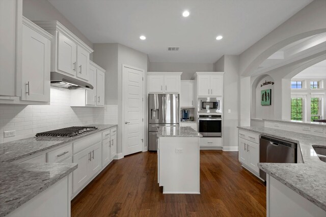 kitchen featuring visible vents, appliances with stainless steel finishes, white cabinets, under cabinet range hood, and recessed lighting