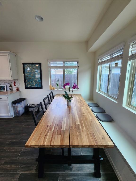 dining room with dark wood-style flooring and plenty of natural light