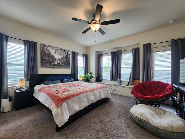 bedroom featuring ceiling fan and carpet
