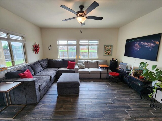 living area with a ceiling fan and wood tiled floor