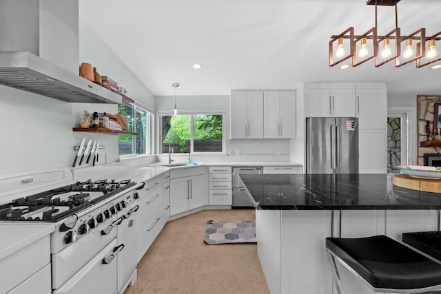 1705 Westmoor Dr, Austin, TX 78723 - kitchen with stainless steel appliances, wall chimney range hood, recessed lighting, a breakfast bar, and white cabinets