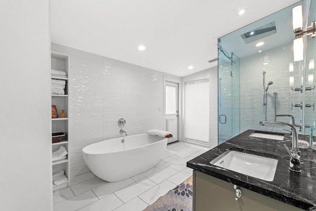 1705 Westmoor Dr, Austin, TX 78723 - full bathroom with a freestanding bath, double vanity, a shower stall, marble finish floors, and recessed lighting