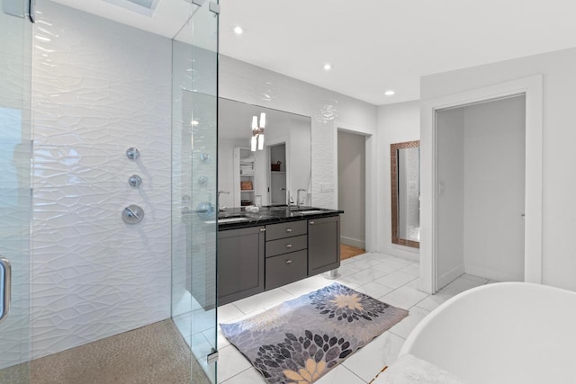 bathroom with double vanity, a soaking tub, tile patterned floors, and a shower stall