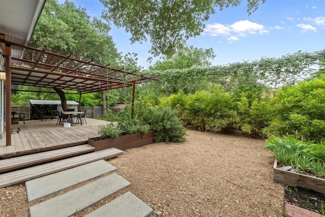 view of yard featuring a wooden deck and a pergola