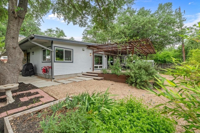 rear view of property with a pergola and a patio